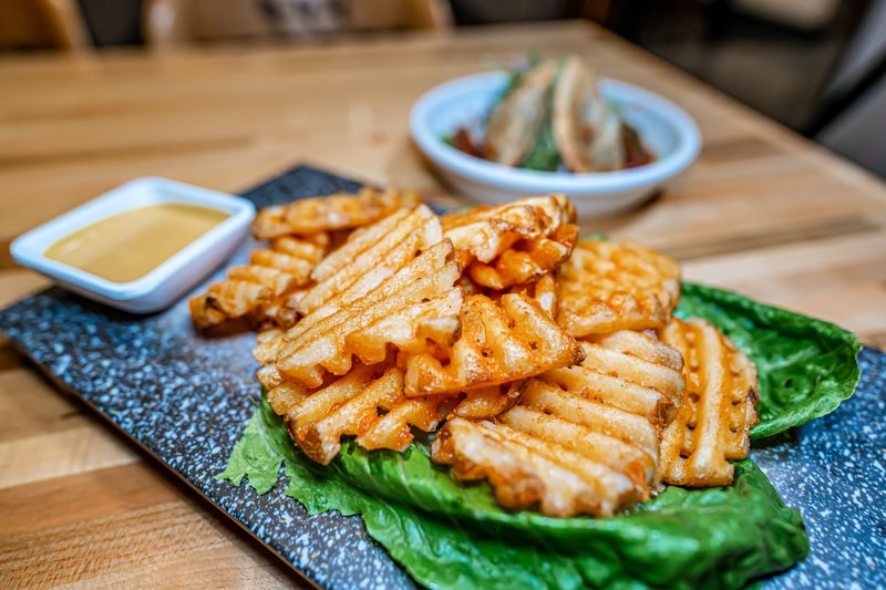 Crispy seasoned waffle fries with dipping sauce